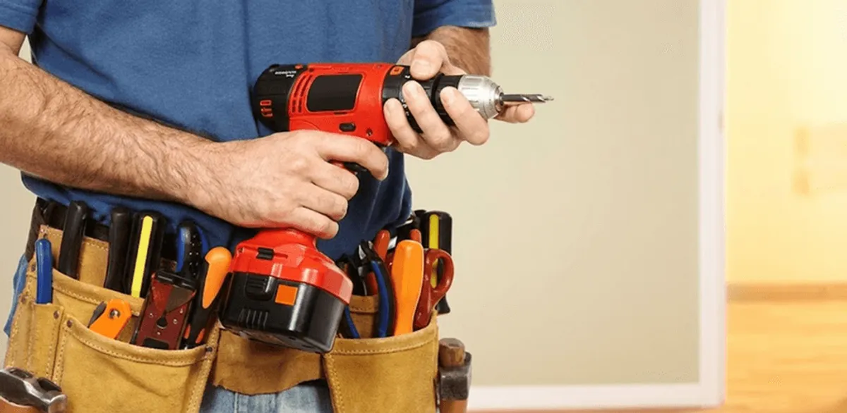Handyman holding a power drill for home repairs and installations in Austin, TX